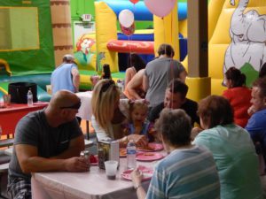 An indoor play area hosting a birthday party for kids.