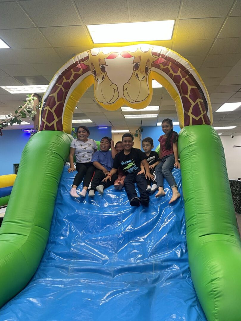 A group of kids on an inflatable bounce house obstacle course.